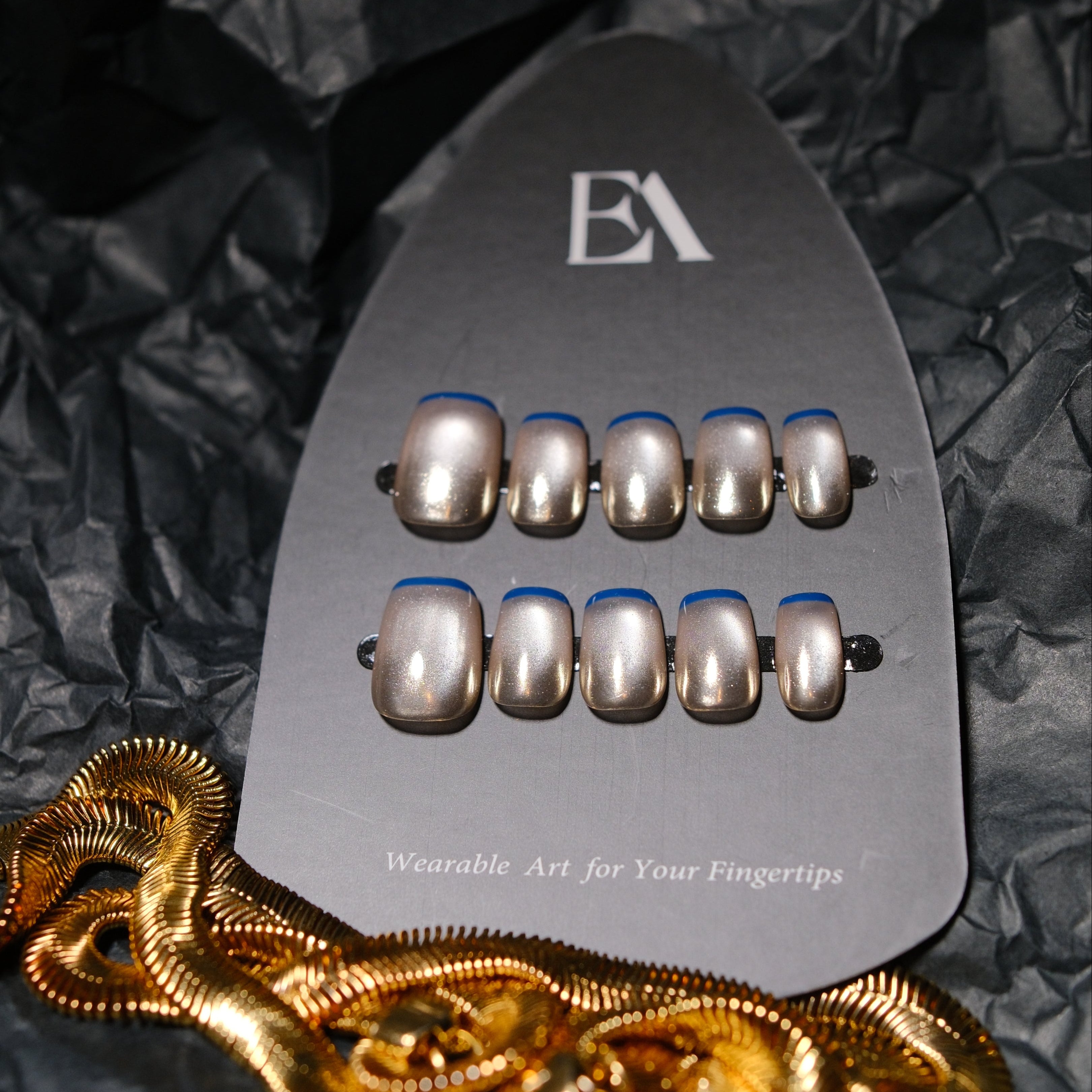 Mercury Edge press-on nail set by Editory — champagne metallic with cobalt blue outline