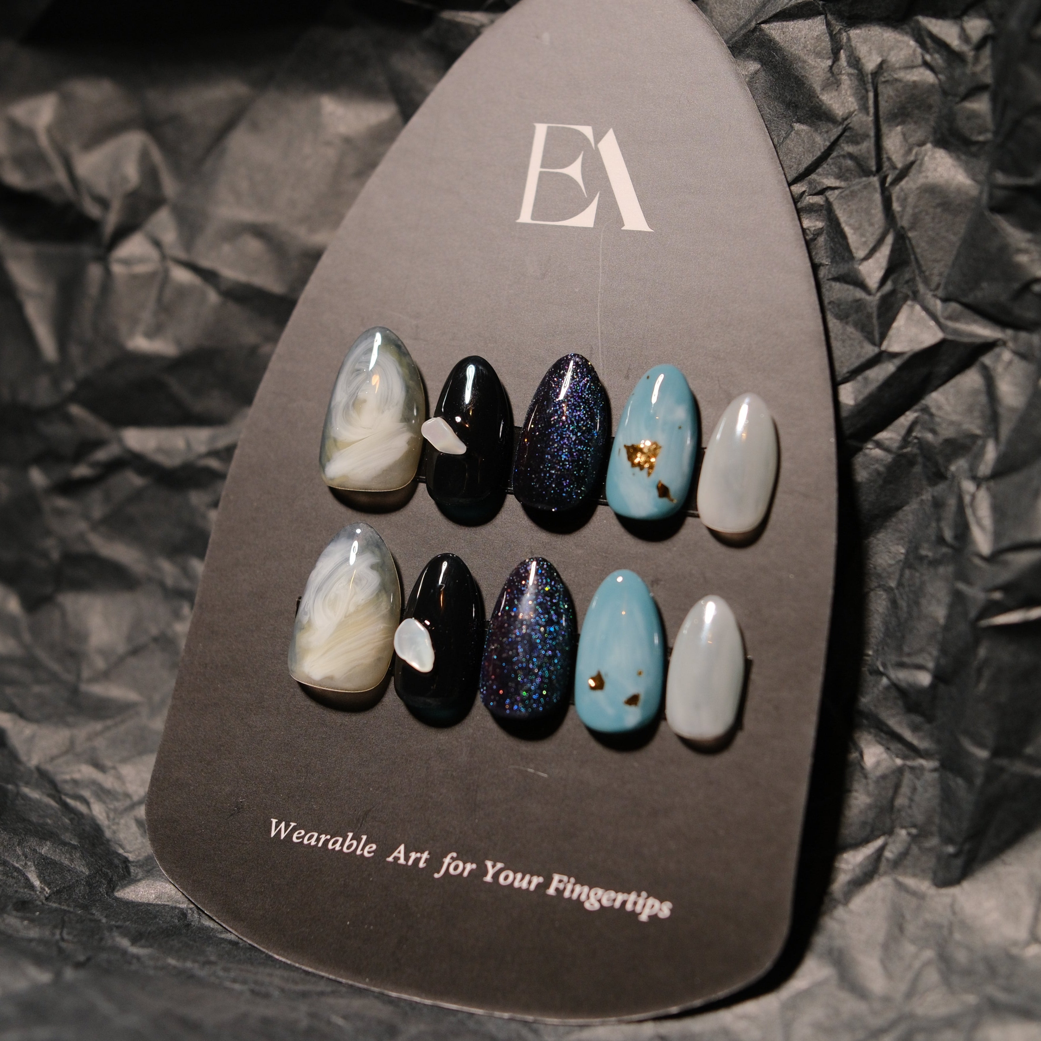 Noir Vein handcrafted press-on nail set by Editory — black marble with stone blue and metallic accents